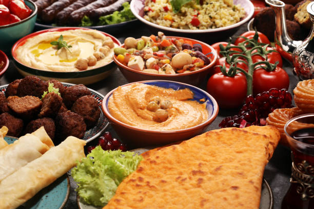 istock Middle eastern or arabic dishes and assorted meze, concrete rustic background. Falafel. Turkish Dessert Baklava with pistachio. Halal food. Lebanese cuisine 1139247201