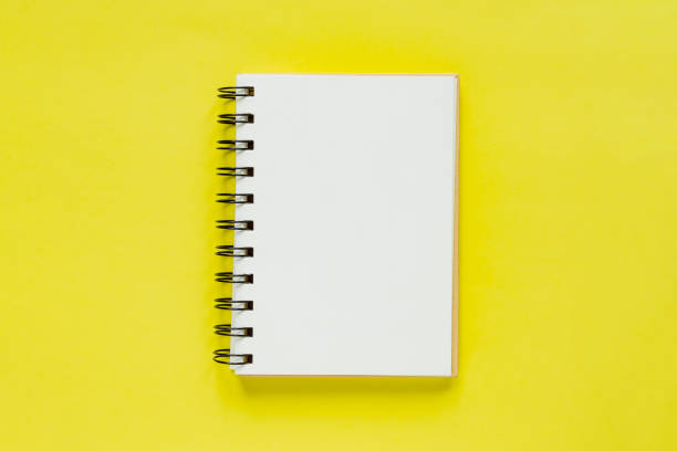 istock Clean note book for goals and resolutions. mockup for your design. Spiral note book on yellow background. 1139249585