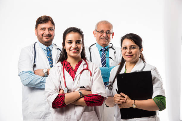 Group of Indian medical doctors, male and female standing isolated on white background, selective focus Group of Indian medical doctors, male and female standing isolated on white background, selective focus india hospital stock pictures, royalty-free photos & images