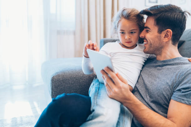 istock Father and daughter looking at digital tablet 1139251629