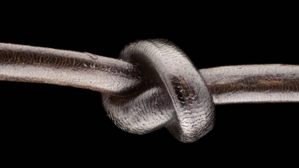 Monochrome macrame, rope tied in knots with copy space