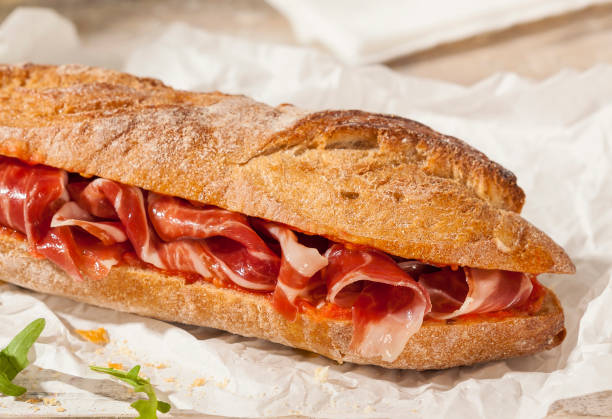 Spanish ham sandwich Crunchy sandwich with Spanish cured ham. appetizer stock pictures, royalty-free photos & images
