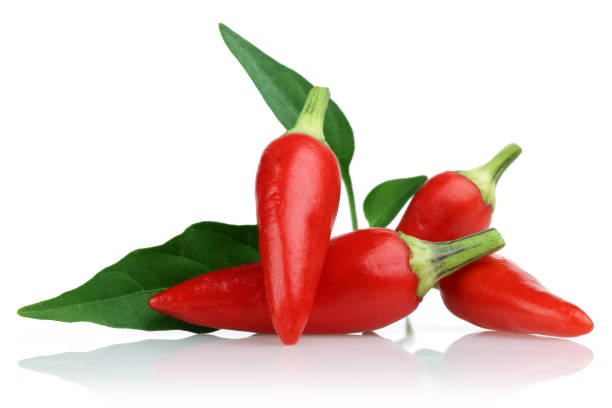 istock Red peppers and leaves isolated on white 1139260518