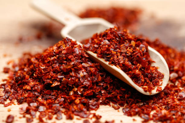 Dried ground red pepper and seeds Dried ground red pepper and seeds on wooden background cayenne powder stock pictures, royalty-free photos & images