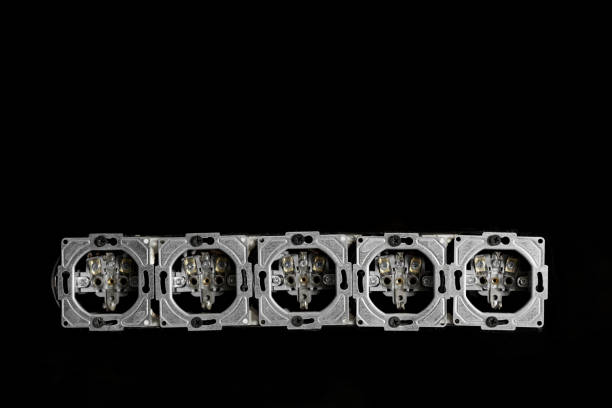 Five outlets in line, disassembled and mounted in black glass wall. Five outlets in line, disassembled and mounted in black glass wall. Faceplate stock pictures, royalty-free photos & images
