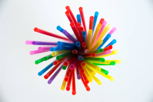 istock Multicolored plastic tubules for a cocktail in a glass on a white background. Polymers in everyday life. 1139262176