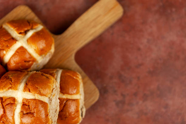 istock Freshly baked hot cross buns on a chopping board 1139263216