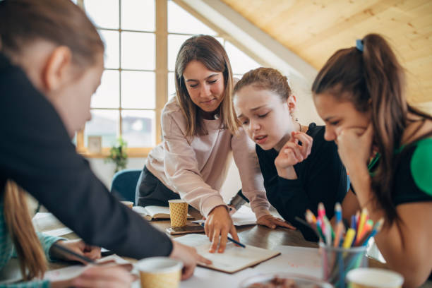 istock Young lady teacher and girls on private class 1139264145
