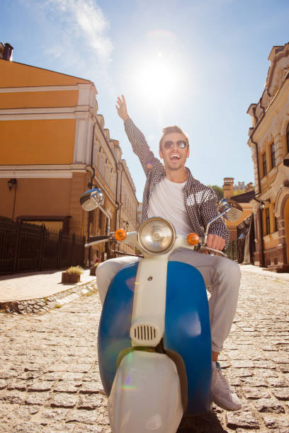 istock Handsome happy man riding a motorbike picking up hand 1139264287