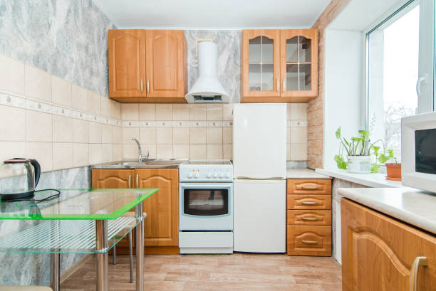 The photo of completely equipped light kitchen with household appliances
