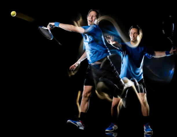 istock tennis player man isolated black background light painting speed motion 1139267740