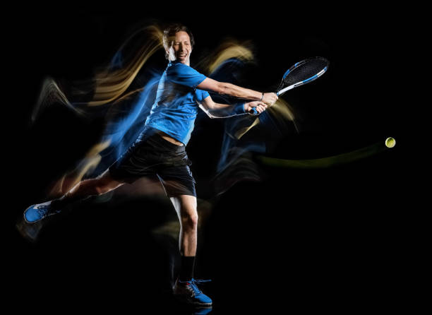 istock tennis player man isolated black background light painting speed motion 1139267751