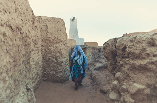Tuareg woman A Tuareg woman walking in the old city of Ghat which is located in the south east of Libya about 1,360 km (845 miles) south of Tripoli near of Algeria & Niger Border. libyan culture stock pictures, royalty-free photos & images