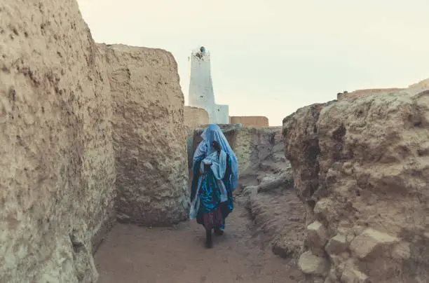 A Tuareg woman walking in the old city of Ghat which is located in the south east of Libya about 1,360 km (845 miles) south of Tripoli near of Algeria & Niger Border.