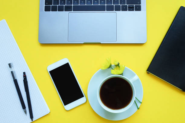 istock Business flat lay: desk with notebook, pencil, cup of coffee on yellow table 1139269643
