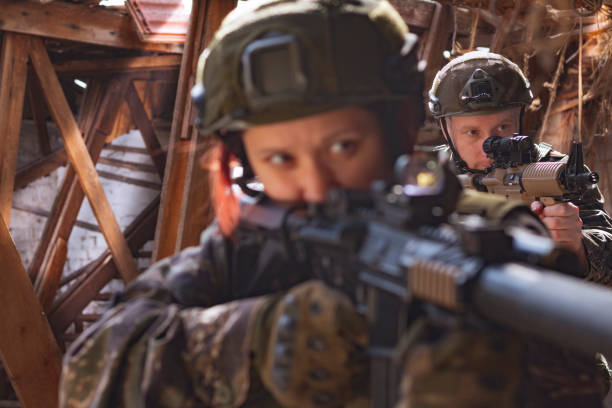 istock Man and woman airsoft shooters aiming 1139272842