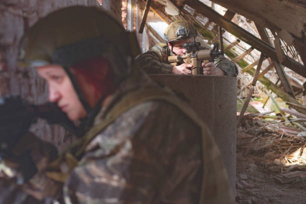 istock Man and woman airsoft shooters aiming 1139272900
