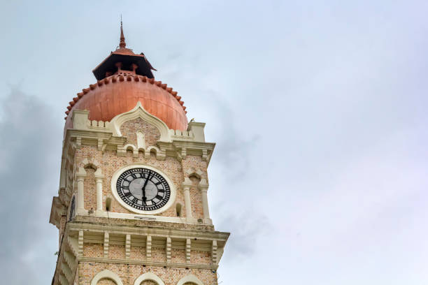 istock Clock on an urban stone tower against a gray sky with clouds 1139274302