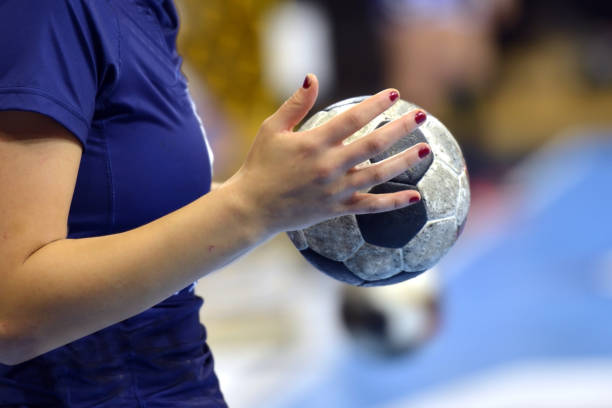 Handball Player Female Handball Player warming up with a handball handball stock pictures, royalty-free photos & images