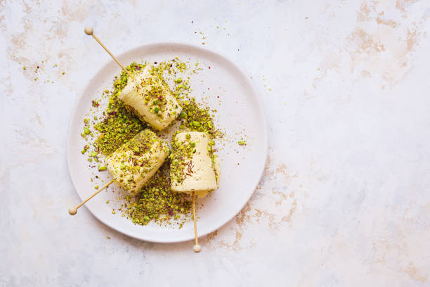 saffron pistachio ice cream kulfi , traditional indian dessert, ready to eat - cardamom spice indian culture isolated imagens e fotografias de stock