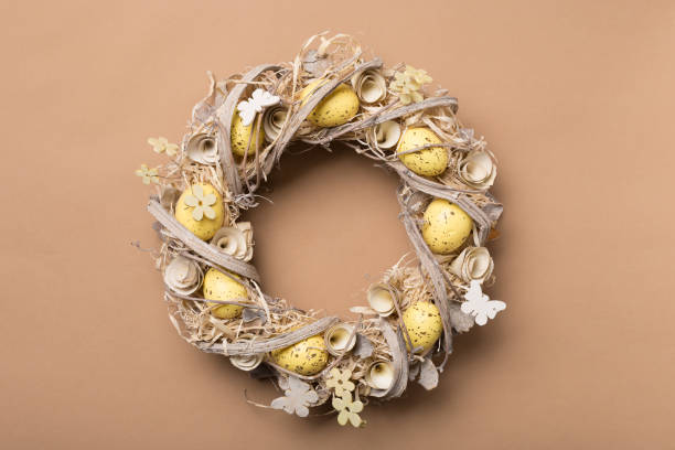Easter wreath made of eggs om beige background. Copy space.