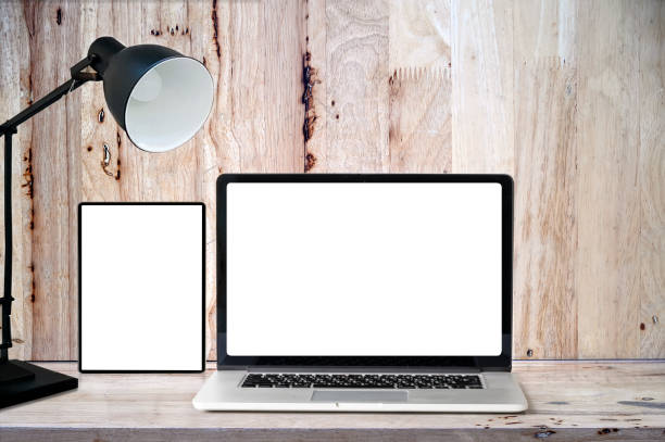 istock Mockup blank screen tablet and laptop on wooden table with copyspace for product display. 1139280000