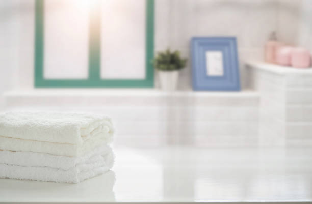istock Towels on white table in bathroom with copy space. For product display montage. 1139280022