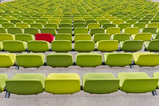 red stadium seat standing out