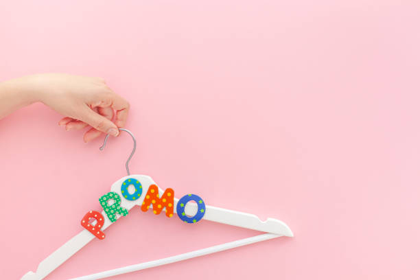 istock White hangers with promo text on pink background 1139281413
