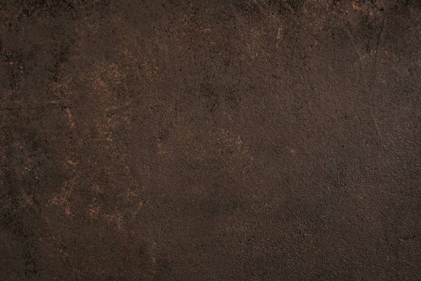 istock Dark brown painted textured surface with golden spots 1139284384