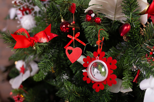 Close up of christmas toys on Christmas tree. Happy New Year and Christmas concept. Decoration.