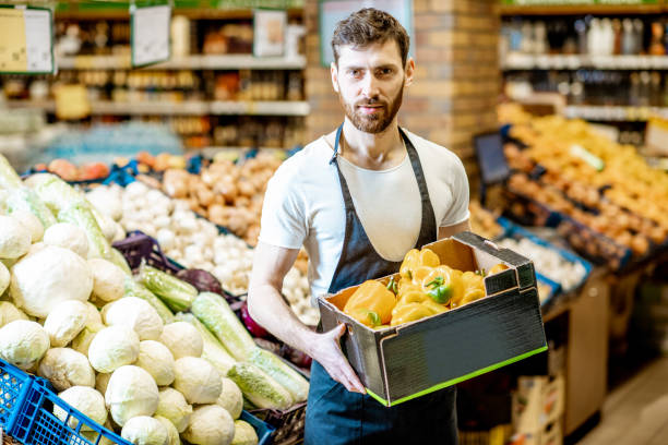 istock Worker with vegetables in the supermarket 1139293247