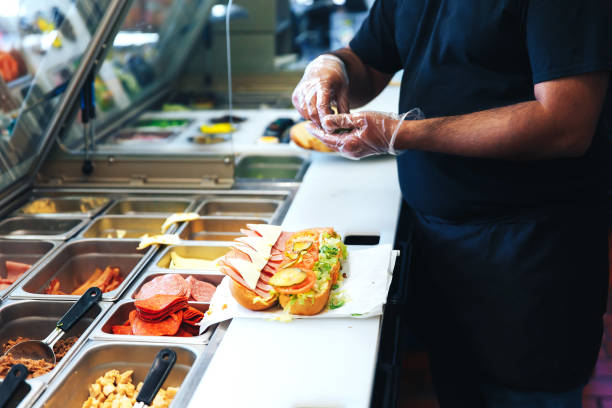 preparando sanduíche no restaurante - fast food restaurant restaurant cafe indoors - fotografias e filmes do acervo