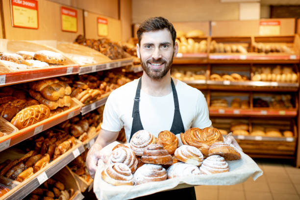 istock Baker with fresh pastries in the supermarket 1139295869