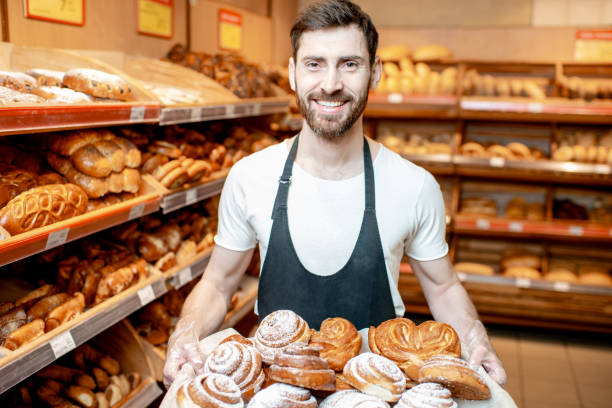 istock Baker with fresh pastries in the supermarket 1139295908
