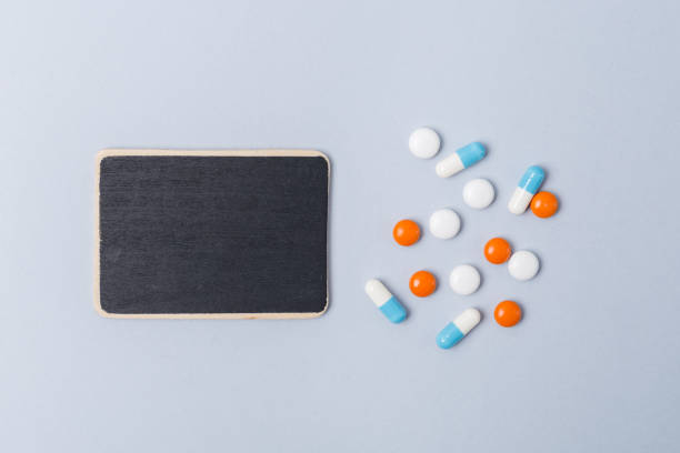istock Assorted pharmaceutical medicine pills, tablets and capsules over blue background and sign for text. .Copy space. Medicine medical concept. Be healthy. 1139299101