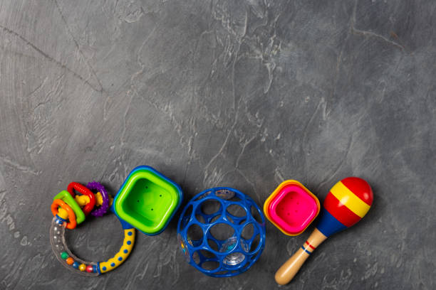 istock Flat lay objects baby toys for development background concept. Table top view variety toys for children play education on dark grey black desk. Copy space for text. 1139299162