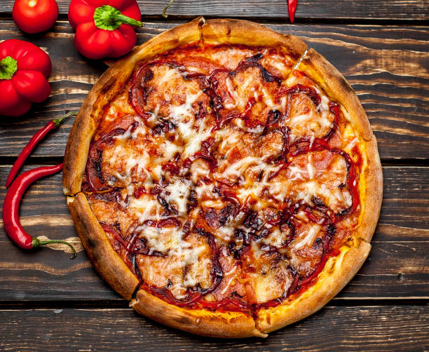 istock pizza on wooden table with ingredients, tomatoes, pepper, onion 1139299195