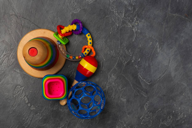 istock Flat lay objects baby toys for development background concept. Table top view variety toys for children play education on dark grey black desk. Copy space for text. 1139299262