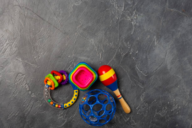 istock Space for text. Baby play development concept. Flat lay objects baby toys for development background concept. Table top view variety toys for children play education on dark grey black desk. 1139299267