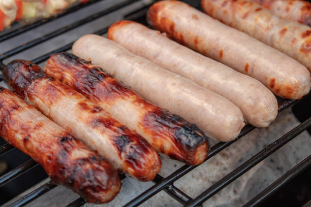 istock Raw and Cooked Sausages on a Barbecue Grill 1139299289