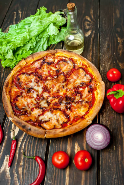 istock pizza on wooden table with ingredients, tomatoes, pepper, onion 1139299311