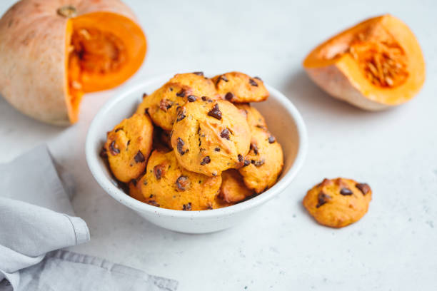 istock Pumpkin cookies with chocolate chips made from cake mix in a white ceramic bowl. 1139299317