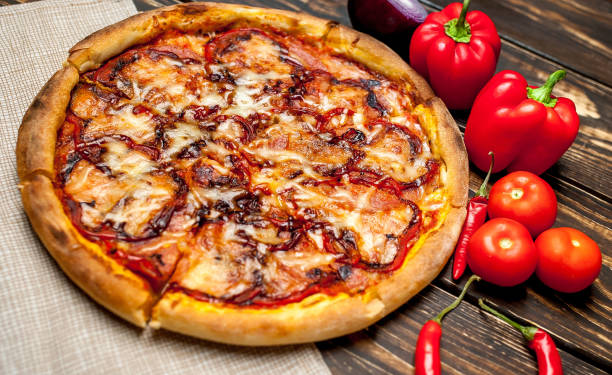 istock pizza on wooden table with ingredients, tomatoes, pepper, onion 1139299319