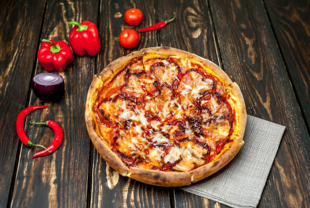 istock pizza on wooden table with ingredients, tomatoes, pepper, onion 1139299419