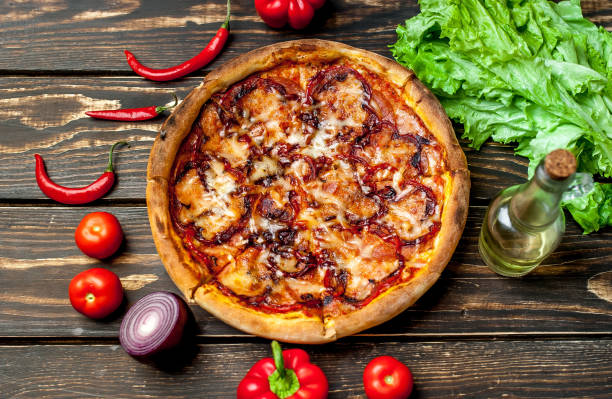 istock pizza on wooden table with ingredients, tomatoes, pepper, onion 1139299538