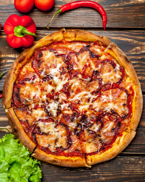 istock pizza on wooden table with ingredients, tomatoes, pepper, onion 1139300069