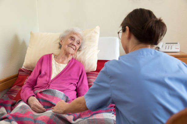 istock Caregiver and senior patient at nursing home 1139300076