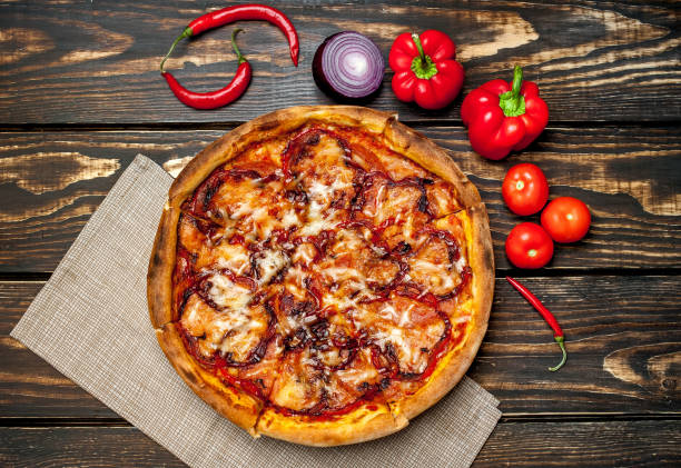 istock pizza on wooden table with ingredients, tomatoes, pepper, onion 1139300091