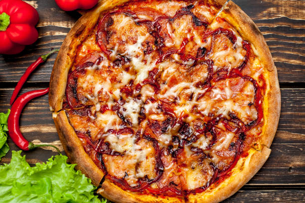 istock pizza on wooden table with ingredients, tomatoes, pepper, onion 1139300112